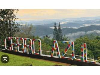 Colorful Cerro Azul sign overlooking lush mountain landscape in Panama