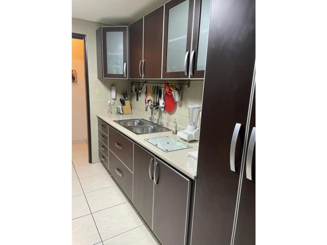 Enclosed kitchen with granite countertops and wood cabinets in PH Coco Mar Coco del Mar Panama