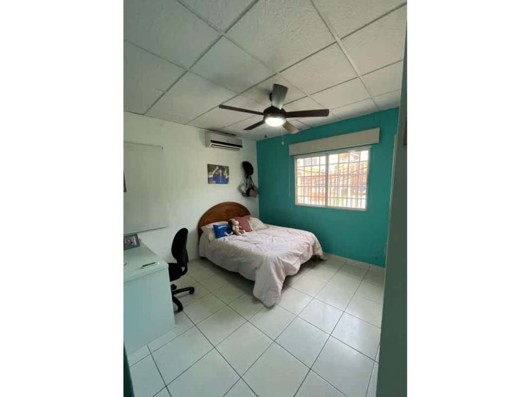 Private yard with grass lawn, brick patio and perimeter wall in Villa Zaita Panama City house