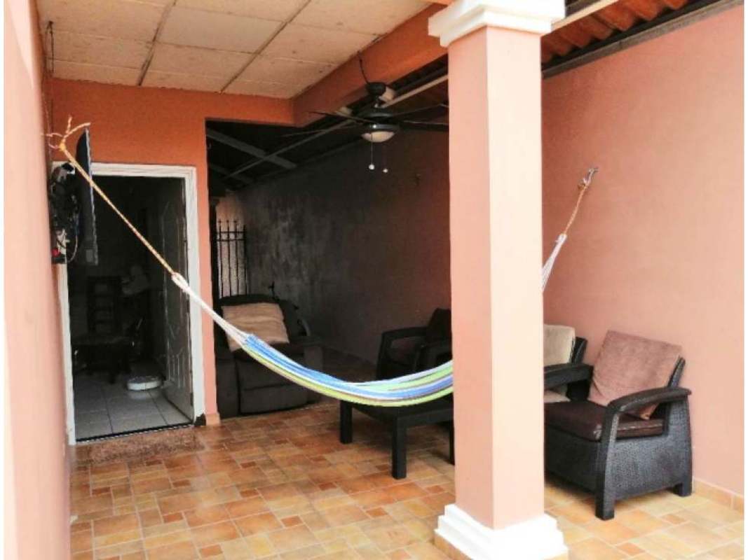 Covered backyard patio with hammock, seating, ceiling fan in Villa Zaita Panama house
