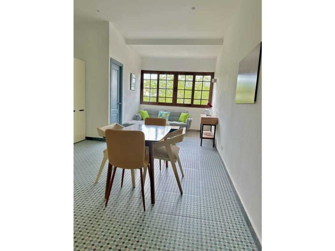 Open-plan kitchen with mosaic tiles and furnished living room at PH Red Plaza Casco Viejo Panama