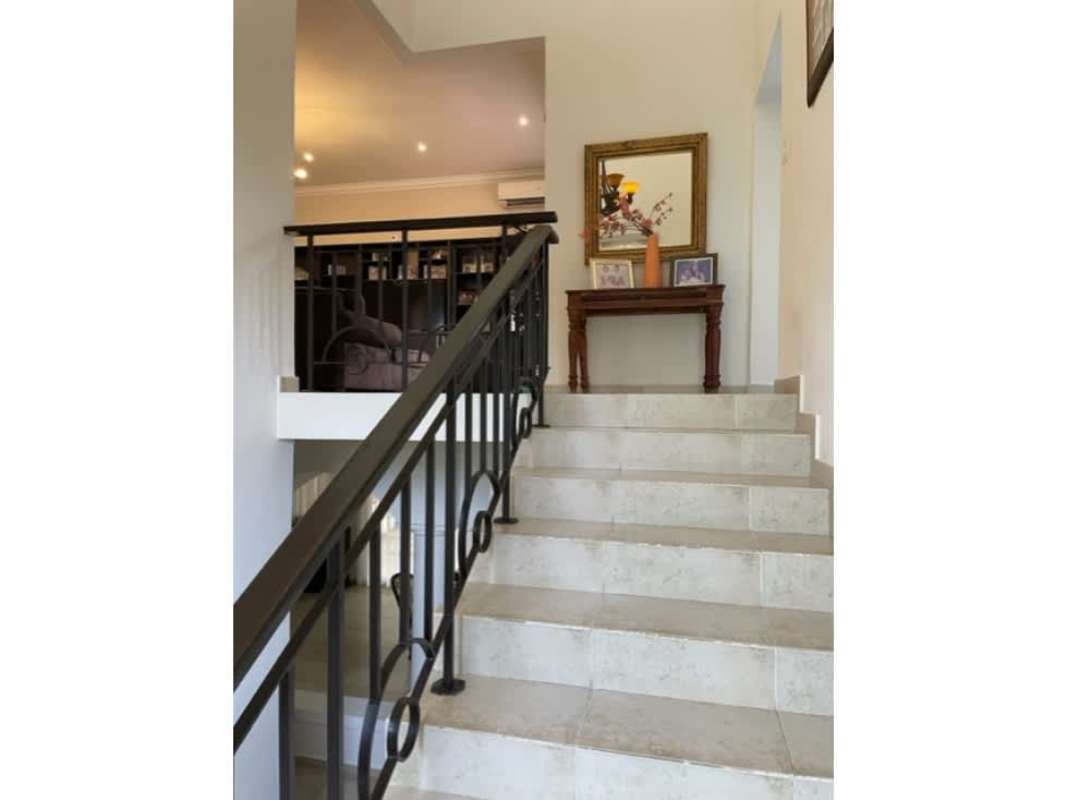 Covered outdoor terrace with garden view and seating in Clayton Village Panama City