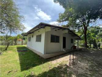 Covered carport next to house in Coronado Panama fenced property