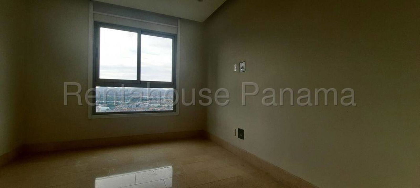 Bright master bedroom with large windows offering golf course and skyline views in Santa María Panama