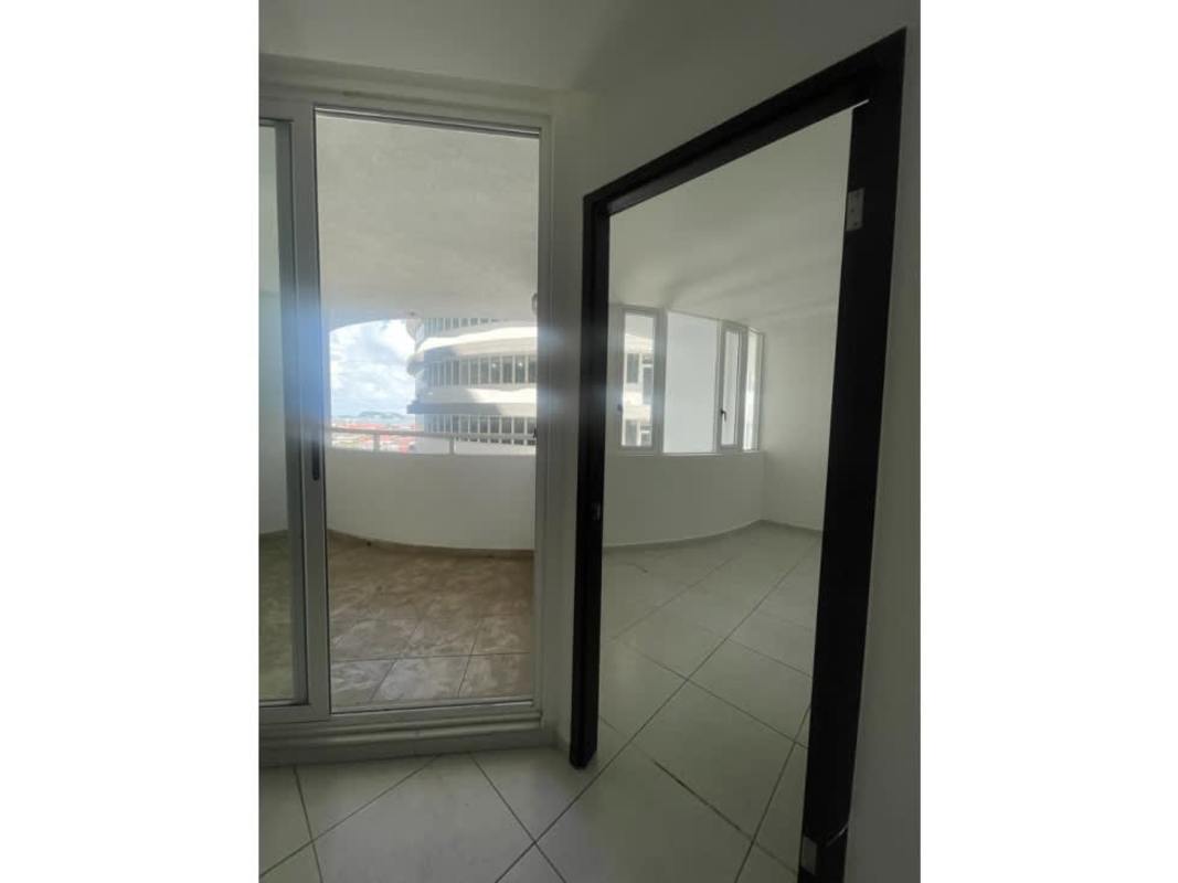 Apartment bedroom with sliding doors to balcony and ocean view in PH Bay View Panama City
