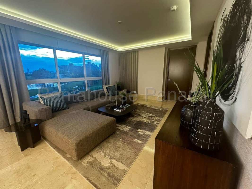 Modern living room with large windows, golf course view in PH The Reserve Santa Maria Panama