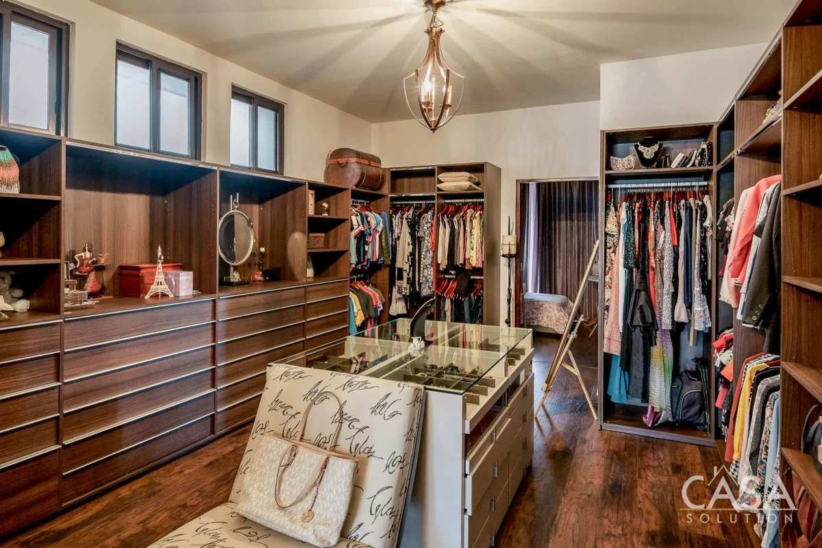 Large bedroom with chandelier, wood floors, elegant decor Embassy Club Clayton home Panama