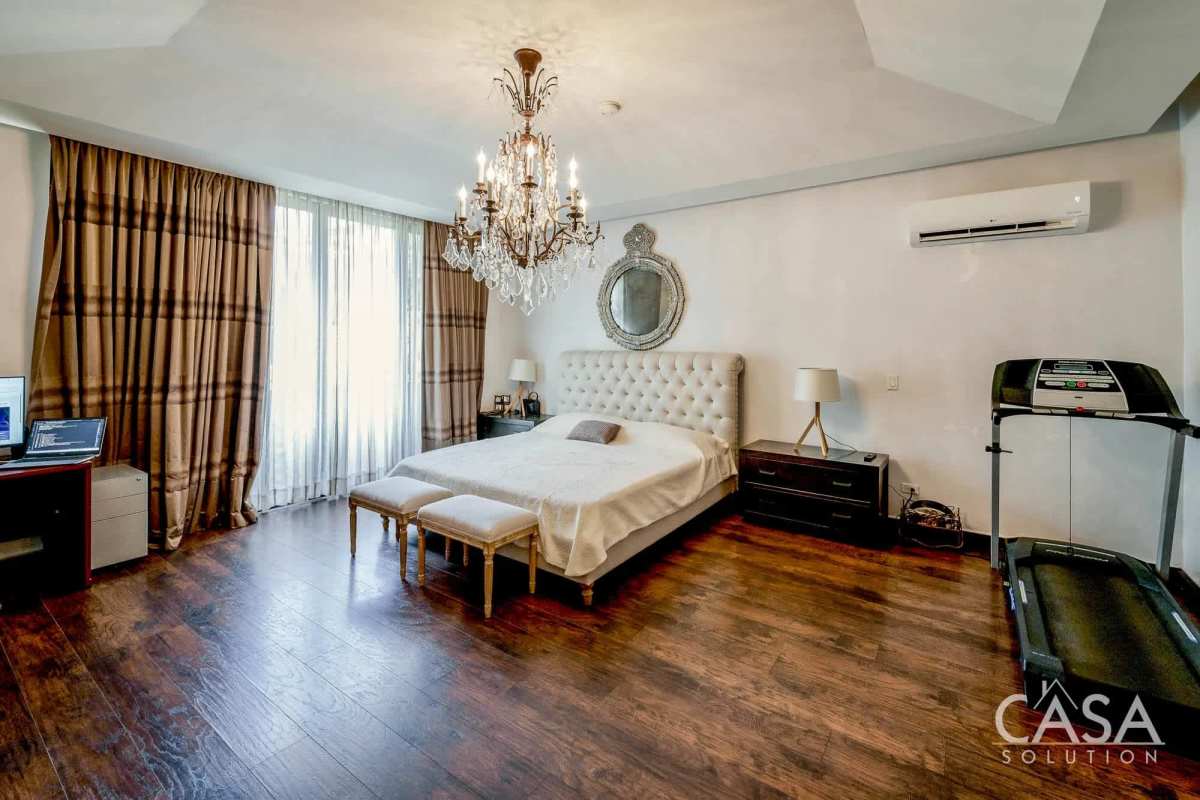 Luxurious custom walk-in closet with island cabinetry in Embassy Club luxury home Clayton Panama