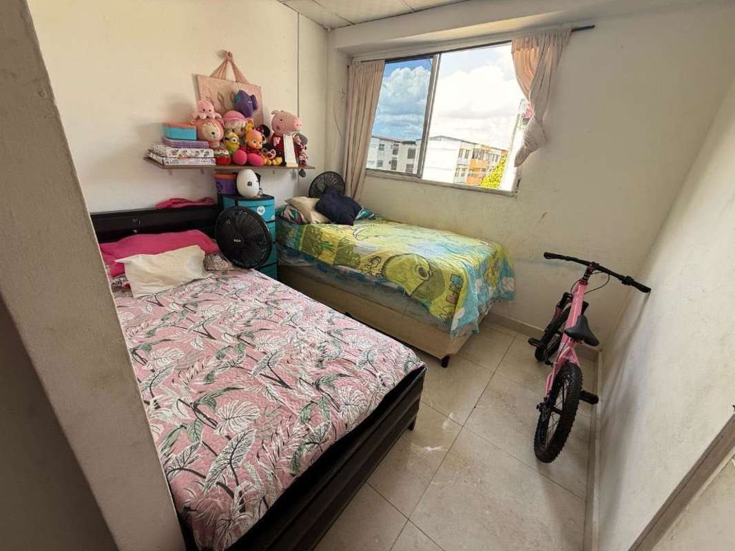 Simple bedroom in residential rental with tile floors and natural light Campo Limberg Residences