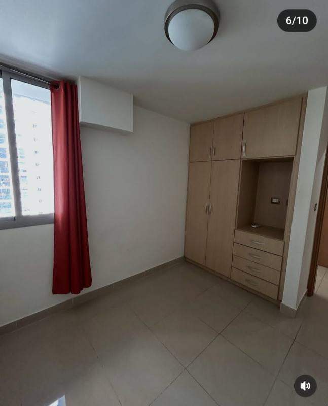 Bedroom with wooden bed, patterned bedding, bedside table, tiled floors in PH Rokas Panama