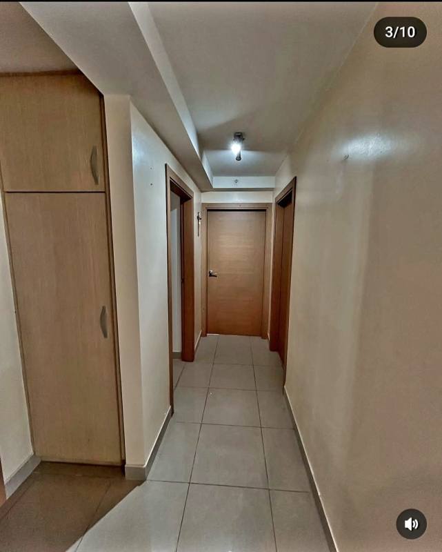 Hallway with tiled flooring, wooden cabinet, neutral walls in PH Rokas Condado del Rey Panama