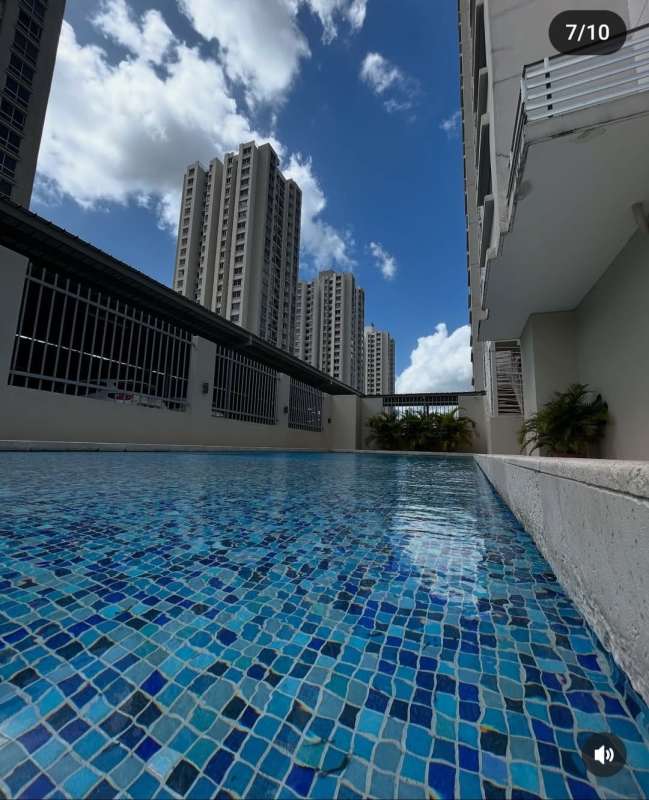 Living dining furnished with brown sofa, orange wall, TV stand in PH Rokas Condado del Rey