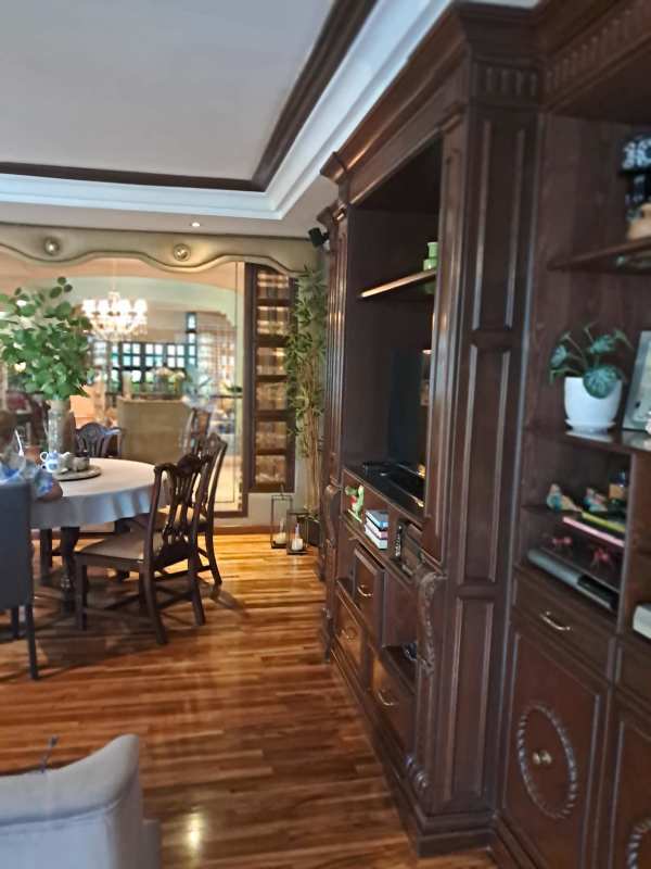 Traditional dining room with chandelier, wooden furniture and stone accents Panama luxury home