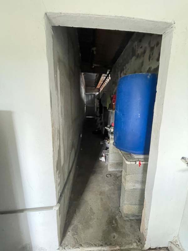 Utility corridor with concrete floor and water tank Los Andes residence Panama