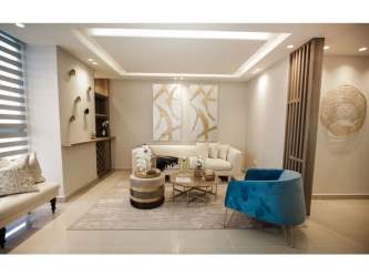 Stylish living area with recessed lights, sofa, blue accents in PH Portofino Panama