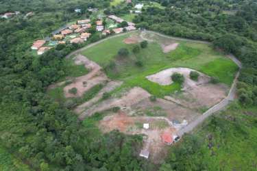 Rural gated entrance through dirt road with lush trees in Las Lajas Chame Panama for sale