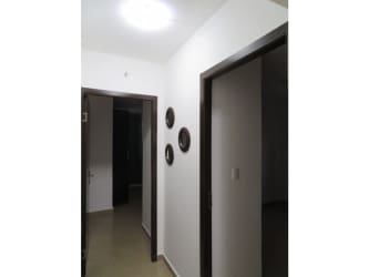 Minimalistic hallway with white walls, brown trim, deco plates in PH Urbis Tower Panama