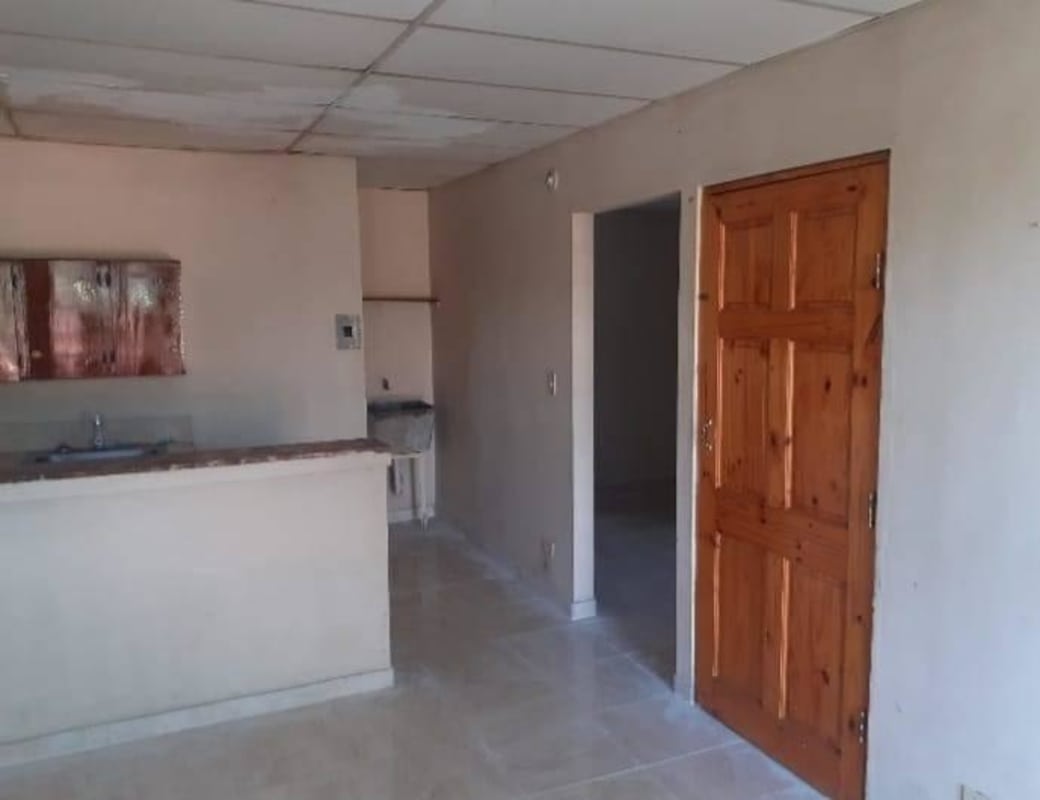 Inside view of front door with kitchen area and wooden door Chepo La Primavera