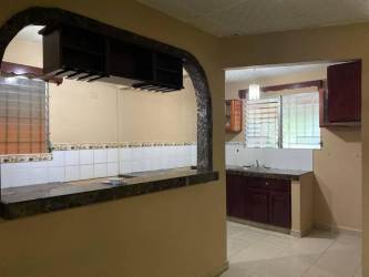 House kitchen with granite counter pass-through wood cabinets tiled backsplash David Panama