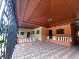 Covered porch with tile wood ceiling chandeliers gated house in David Chiriquí Panama