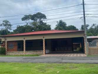 Front exterior with brick stucco facade, gated entrance single story house in David Panama for sale