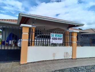 Single story home with tiled porch, fenced perimeter, gated carport in San Pablo Viejo David Chiriquí Panama