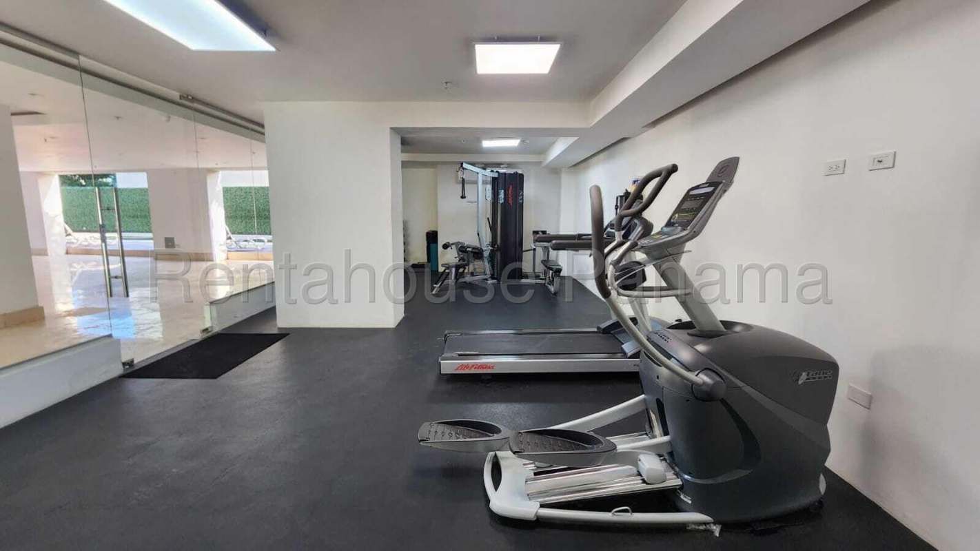 Modern bedroom with marble floors, large windows, golf course view in Santa Maria Signature apartment