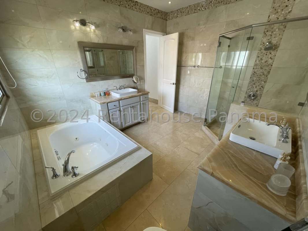 Grand marble staircase with glass railing double height ceiling foyer luxury Santa Maria mansion Panama