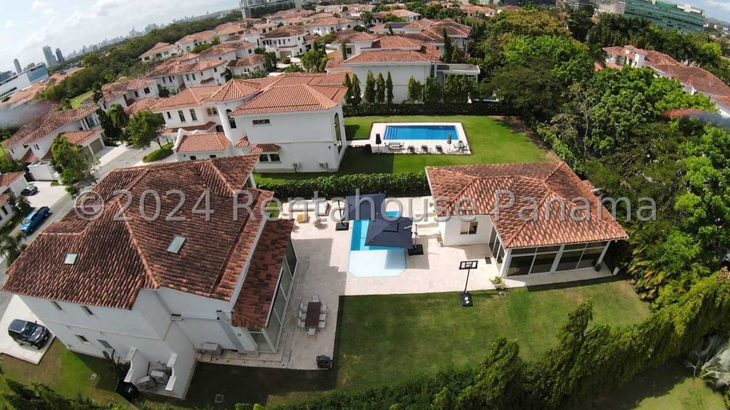 Mediterranean two-story mansion with terracotta roof, palm trees, and manicured lawns in Santa Maria Golf Panama