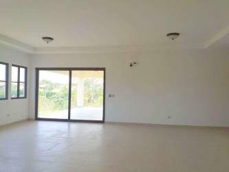 Modern open living room with sliding glass doors to garden at Hacienda Pacifica San Carlos