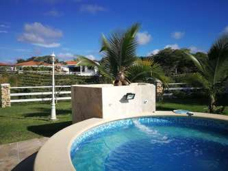 Outdoor tropical garden with circular pool and palms in Hacienda Pacifica San Carlos