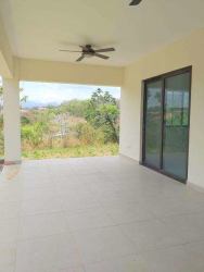Covered patio with ceiling fan ceramic tiles and garden view at Hacienda Pacifica San Carlos