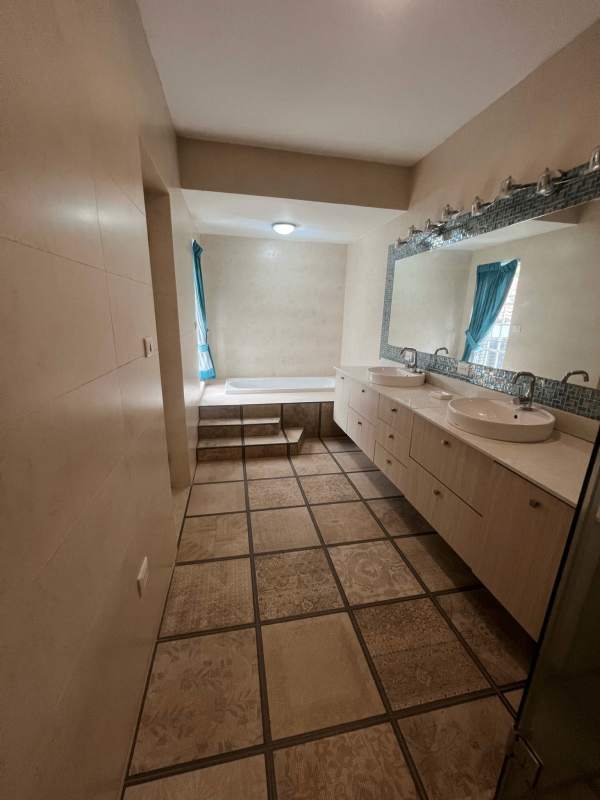 Spacious dining area with chandelier and marble floors in Altos de Golf home Panama City