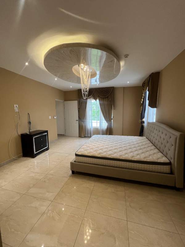 Contemporary master bath with bathtub, double vanity and mosaic accents Panama City