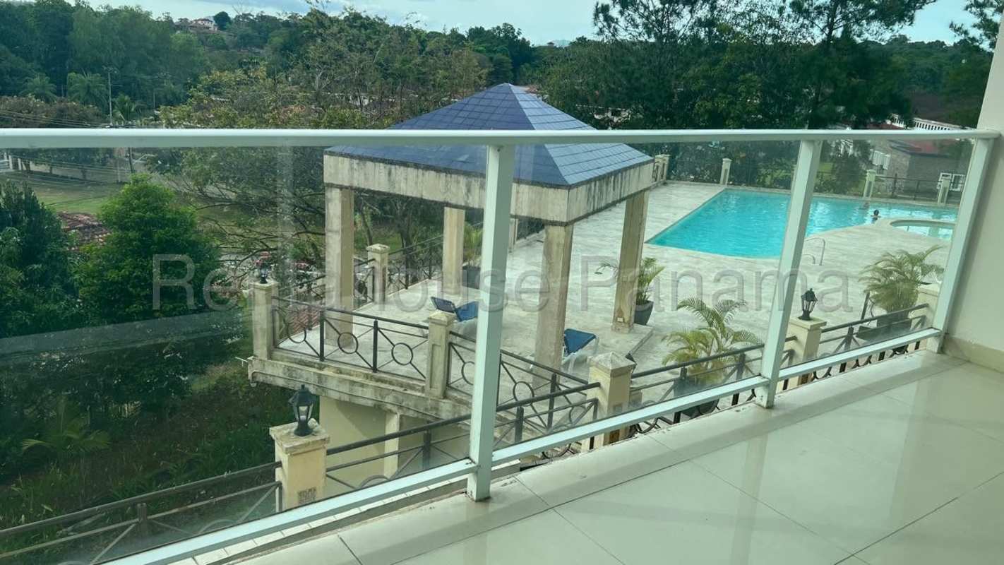 Outdoor swimming pool with lounge chairs surrounded by green areas in PH Pine Hills Albrook Clayton Panama