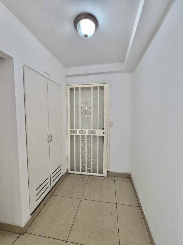 Bedroom with tiled floor, window, study desk, green curtains in PH Green Park Condado del Rey Panama City