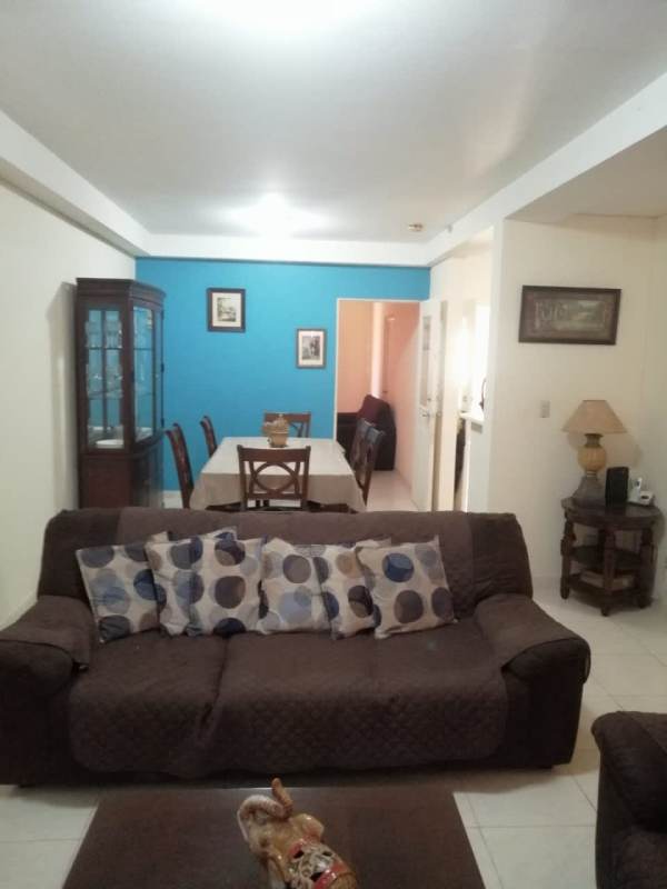 Spacious living room with sofas, TV, tiled flooring in home in Cerro Viento Panama City