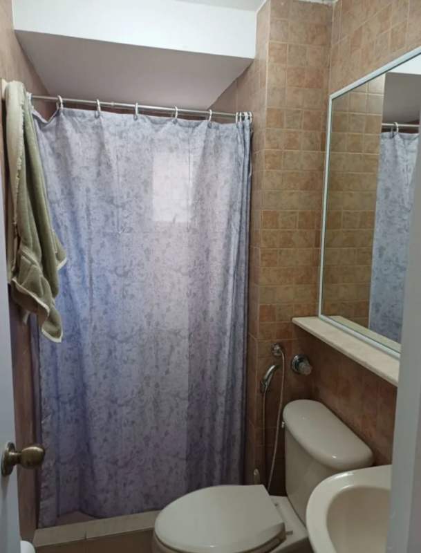 Bathroom with ceramic tiles mirror and glass shower door apartment rental Panama San Francisco