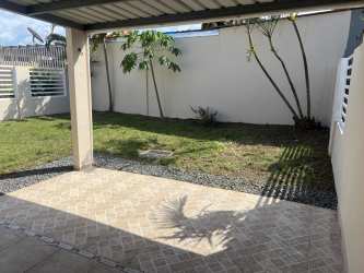 Covered patio backyard area with lawn and privacy wall La Chorrera Panama