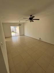 Spacious living room with ceiling fan and sliding glass doors in Panama West house