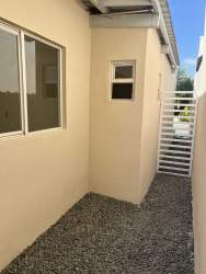 Side gravel yard with metal gate Arboledas Cluster Los Olivos Panama