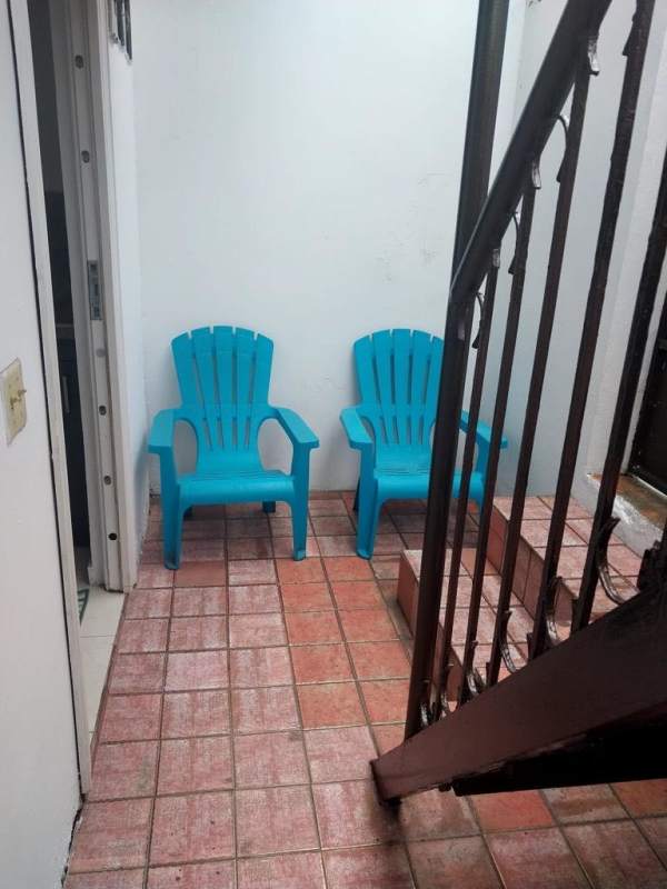 Outdoor patio with two blue chairs and tile floor in Paseo del Valle Villa Lucre Panama City