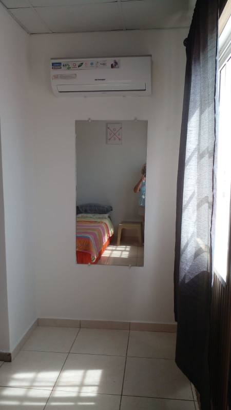Bedroom with air conditioner and mirror in Paseo del Valle Villa Lucre Panama