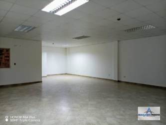 Bright empty commercial space with fluorescent ceiling lights, ready for lease in David business sector