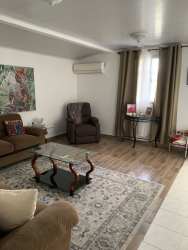 Cozy living room with wood look flooring, AC unit, and seating Urbanización Valle Dorado Panama
