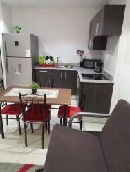Kitchen with modern cabinetry and dining area in furnished beachfront apartment Playa Corona San Carlos Panama
