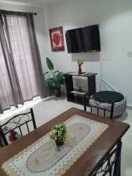 Bright bedroom with teal curtains, air conditioning, double bed in Playa Corona Residences Panama