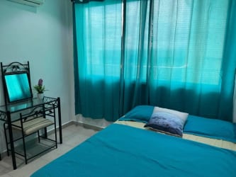 Open-plan living room with dining table, TV, and decor in Playa Corona Residences San Carlos Panama