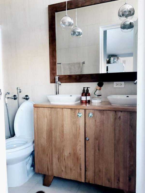 Contemporary bathroom with double sink, wood vanity, modern lighting PH Vivendi Tower Panama