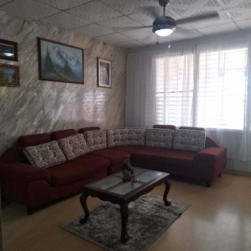 Single-story house with mature trees, paved parking and metal fence in Villa Lucre Alto de la Pulida Panama